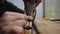 Wood carver engraver carves ebony cross carvings. carpenter working with a drill. The sounds of hand instruments