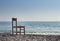 A wood chair abandoned on the beach