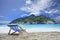 Wood chairs deck on white sand beach with clear blue sea water a