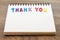 Wood colorful letter word THANK YOU lay down notebook on wood ba