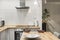 The wood countertop kitchen with gloss white wood cabinetry, matching