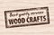Wood craft stamp on wooden background. Wood works professional service. Grange print stamp in brown.