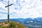 A wood cross on top of the mountain Kalmberg and rays of the sun. Beautiful landscape. Salzkammergut region
