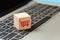 wood cube block with shopping cart icons on keyboard laptop, online shopping concept.