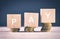 Wood cube with word PAY and stacking coin on wooden table