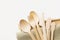 Wood cutlery spoons fork knife on beige linen cloth white wall background. Zero waste plastic free reusable biodegradable