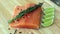 Wood cutting board in kitchen table with fresh red salmon fish salt pepper and lime ready to cook.