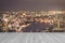 Wood deck in grey tone with blurred abstract background of night light of Bangkok cityscape on Chao Phraya Riverfront