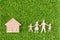 Wood Family Shaped and Home Shaped on green grass.  Green Family Concept