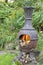 Wood fire flames in chiminea garden barbecue