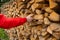 Wood firewood.solid fuel.Woodpile and hands. Heating season.Mens hands in a red jacket takes firewood