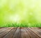 Wood floor with green bokeh and Fresh spring green grass and sunlight