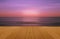 Wood floor on sea with purple sunset Burning Skie beautiful natural tropical sea