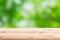 Wood foreground with blur green forest background