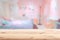 Wood foreground with blur pink lovely bedroom