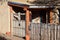 Wood gate to patio entrance of adobe house