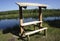 A wood gazebo over looks the River in on a blue sky day