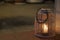 A wood and glass candle lantern illuminates the way during a beach ghost tour in Tuscany, Italy