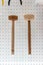 Wood hammers hanging against white dot wall background