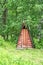 Wood house in forest. Local travel concept. Sustainable lifestyle. Summer