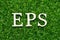 Wood letter in word EPS Abbreviation of Earnings per share on green grass background