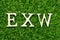Wood letter in word EXW abbreviation of Ex works on green grass background