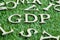 Wood letter in word GDP Abbreviation from Good distribution practice or Gross domestic product on artificial green grass