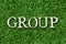 Wood letter in word group on green grass background