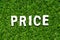 Wood letter in word price on green grass background