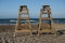 Wood lifeguard post in the beach. Sunset horizon line between sk