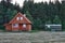 Wood log cabin near forest in cloudy day and mobile transport ca