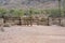 Wood log fence at the start of a hiking trail in the desert