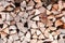 Wood logs pile background texture close up side view. Woodpile firewood fireplace concept copy space