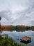 Wood masonry at lake. Rotten pier on the shore of a calm morning reservoir