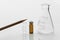 Wood orange pencil and glass vial and chemistry science flask white laboratory class education background