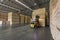 Wood pallet forklift driving at a factory floor inside a shed