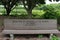 A wood park bench engraved with a quote by John James Audubon in a park in Wisconsin