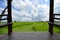 Wood pavilion in rice under cloudy sky