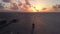 A wood pier or walkway with a palapa at the end at a holiday resort near Cancun, Mexico at sunrise.