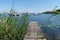 Wood pontoon in Lacanau lake with boat in France