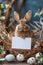 A wood rabbit is sitting in a grass nest holding a sign
