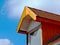 wood roof dormer with sloped red clay tile roof. blue sky and cloud. home ownership