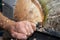 Wood sawdust shavings squirting while creating timber bowl