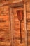 Wood shovel on cottage wooden wall. Decorative shovel made of wood. Wooden shovel hung in the hanger. Textured wood shovel