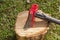 A wood splitting maul on top of a wooden log