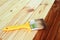 Wood staining. Brush. Painting wooden patio deck with protective varnish