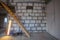 Wood stairs, luminous tube lamp and materials for repairs and tools in the house building that is under remodeling, renovation