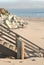 Wood stairs and rocks on beach in California