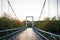 Wood suspension bridge over the river in the mangroves forest for travel with beautiful sunshine background