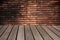Wood table and abstract red brick wall Background.